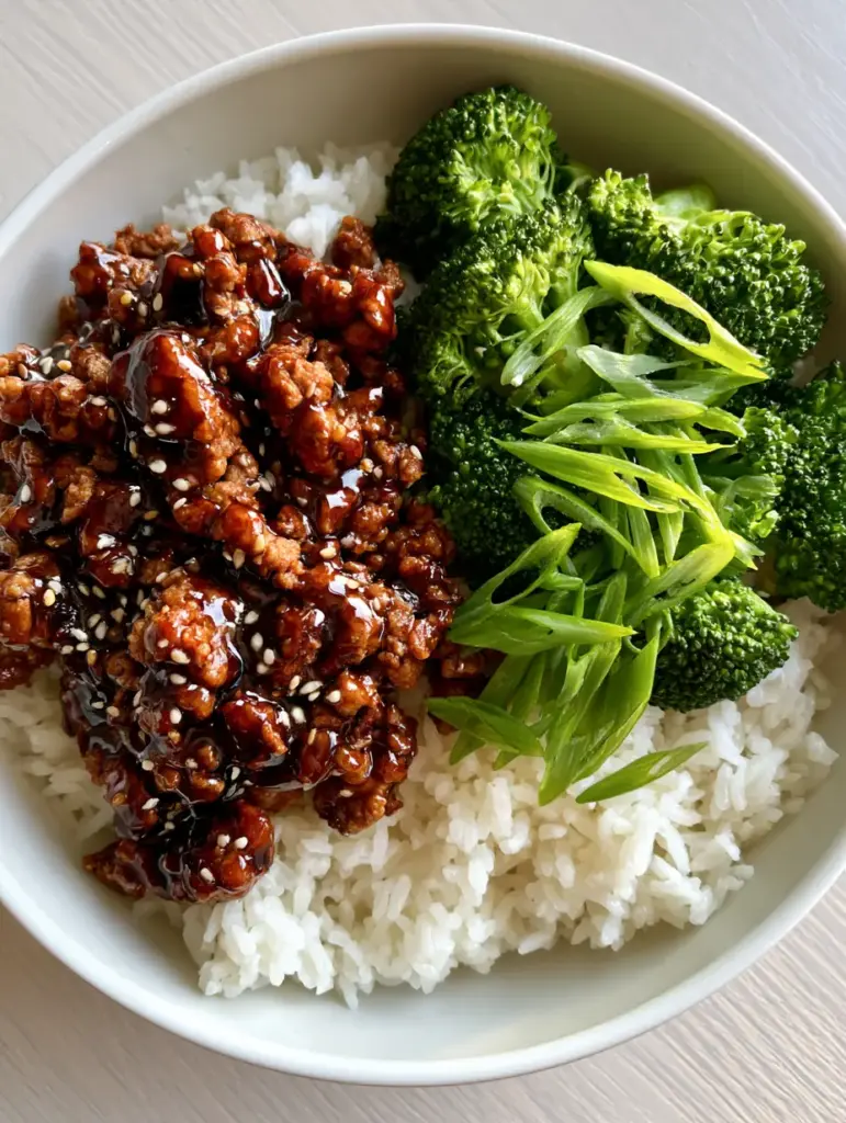 A smartphone-style photo of a Honey Garlic Ground Turkey Skillet bowl showing the tender-crisp texture of the broccoli florets and reflective glaze.