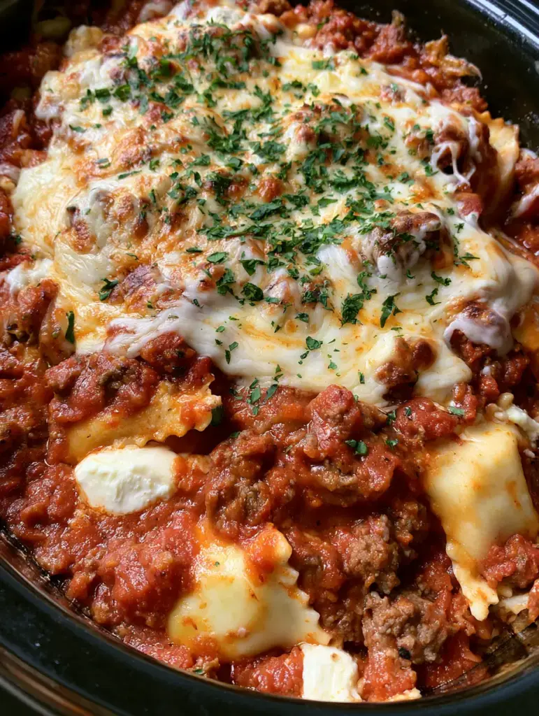 Million Dollar Ravioli Crockpot: The Ultimate Cheesy Slow Cooker Dinner 1 Slow cooker ravioli with dollops of white ricotta cheese and melted mozzarella.
