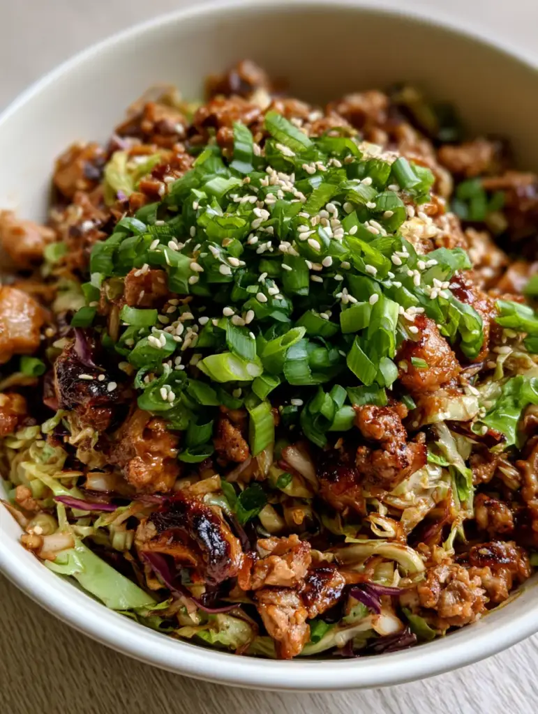 Egg Roll in a Bowl: The Ultimate 20-Minute One-Pan Healthy Dinner 1 Close-up of Egg Roll in a Bowl garnish with green onions and white toasted sesame seeds.